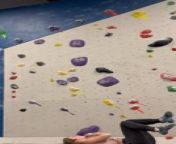 While climbing at an indoor bouldering gym, this woman was reaching the top of the challenging yellow V6 route. As she reached for the last hold, her hand slipped, causing her body to twist away from the wall and leading to a fall from a height of approximately 15 to 20 feet. Despite such a fall, she laughed her embarrassment away.&#60;br/&#62;&#60;br/&#62;The underlying music rights are not available for license. For use of the video with the track(s) contained therein, please contact the music publisher(s) or relevant rightsholder(s).