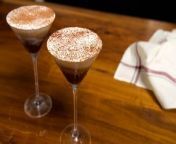 In this video, learn how to make a refreshing and light Tiramisu Frozen Espresso Martini with homemade whipped cream. Straightforward and simple, this chilled drink recipe starts by freezing coffee and espresso in an ice cube tray. Next, add the ice cubes into a blender with sweet agave syrup, vodka, and vanilla extract. Finally, whisk together the whipped cream, add to the mixture, and garnish with cocoa powder.