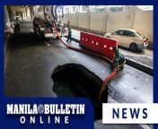 Workers drain the water from a sinkhole or deep hole that suddenly appeared along Sales Road in Pasay City on Sunday, April 14, 2024. The Metropolitan Manila Development Authority (MMDA) advised motorists to take alternate routes to avoid inconvenience. (MB Video by Arnold Quizol)