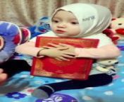 this cute little baby girl refuse to exchange her holy Al Qur&#39;an with smartphone