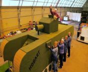 A community group has knitted a life-sized tank to commemorate the 80th anniversary of the D-Day landings.&#60;br/&#62;&#60;br/&#62;Around 30 volunteers spent eight hours a day for nine months knitting eight-inch squares for the artwork, which was modelled on a Churchill AVRE tank.&#60;br/&#62;&#60;br/&#62;The stunning creation is now a whopping 24ft (7.3cm) wide and 7ft (2.1m) tall and is covered in the olive green squares that the volunteers knitted.&#60;br/&#62;